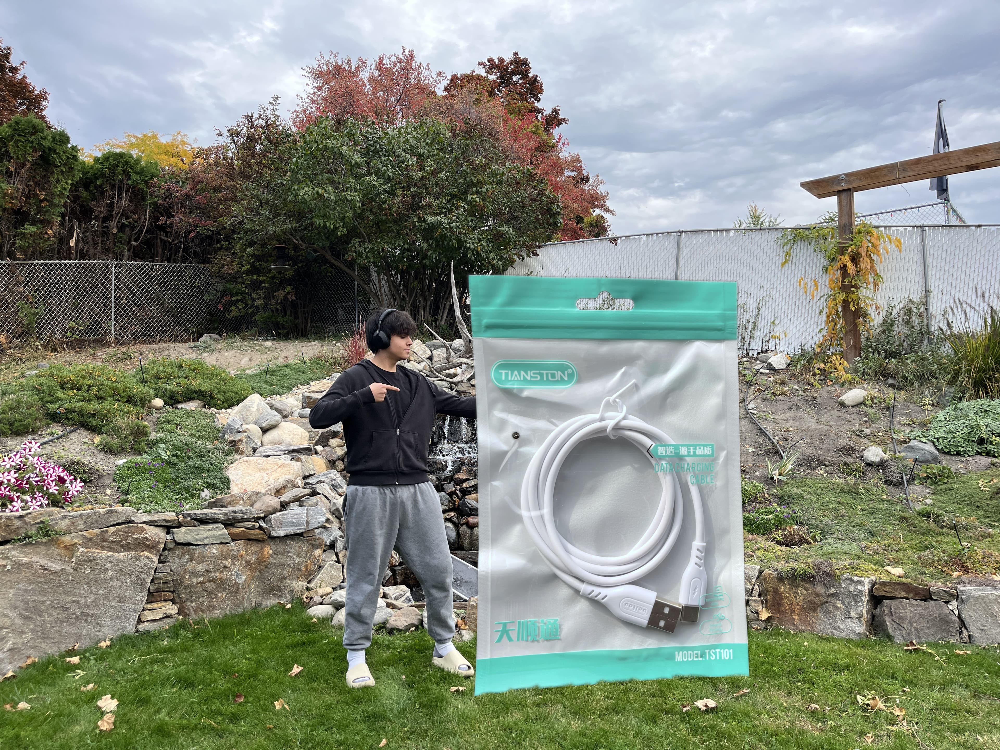 Ethan Breitkreutz, developer of literally one charger, holding a life size charger.